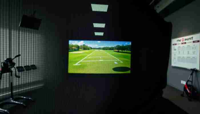 Close-up of a reinforced golf simulator impact screen with stitched edges and durable home setup construction