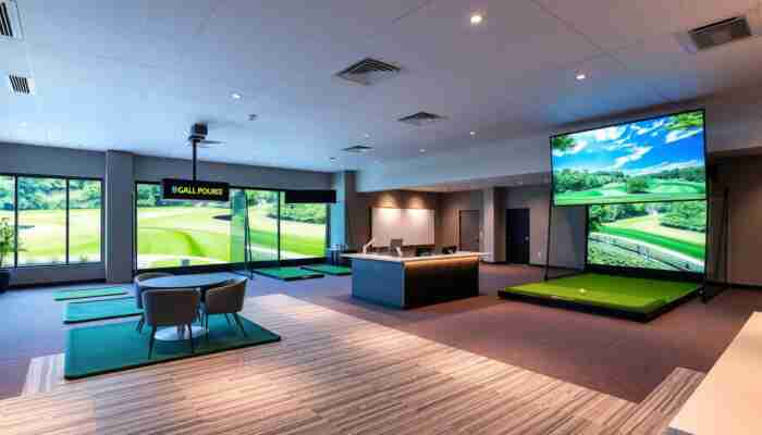 Modern commercial indoor golf facility with multiple simulator bays, reception space, and premium customer environment.