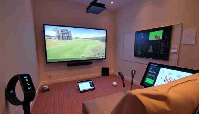 Modern golf simulator in a small space with connected devices and performance metrics on screen