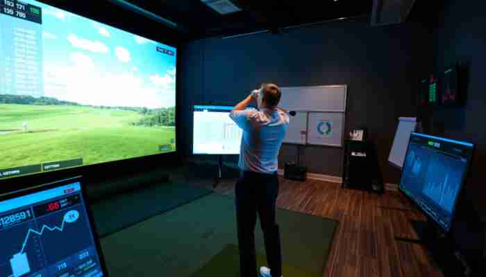Commercial golf simulator facility showing player practice, shot tracking and performance data