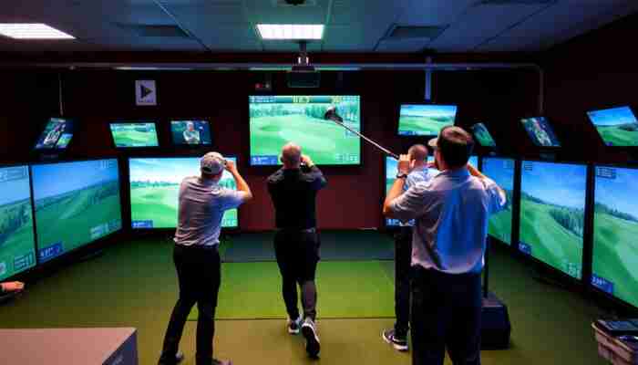 Friends enjoying a multiplayer session on an indoor golf simulator