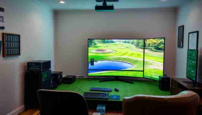 A modern home golf simulator setup featuring a multi-core CPU, dedicated graphics card, and a monitor displaying vibrant 3D graphics of a golf course in a cozy room.